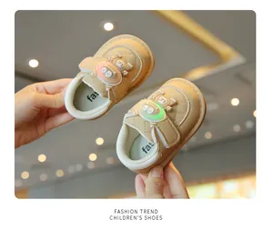 Detail view of khaki baby light-up walking shoes with glowing cartoon strap