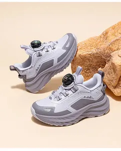 Close-up of children's breathable gray outdoor hiking shoes with rotary buckle system
