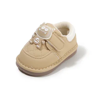 Khaki toddler walking shoes featuring a cute cartoon monster design and soft non-slip sole