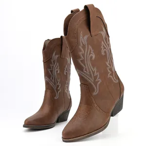 Detail view of women's brown embroidered cowboy boots with sturdy block heel