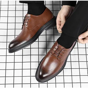 Detailed view of elegant brown textured leather business dress shoes with pointed toe