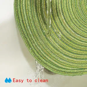Detailed view of a washable round woven placemat being cleaned under running water