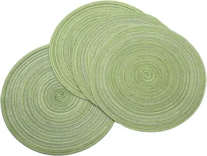 Set of 4 light green circular woven placemats with heat-resistant spiral texture