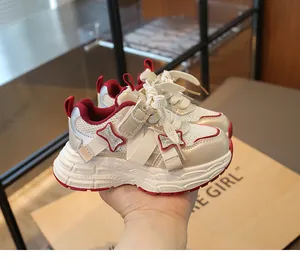 Breathable girls' chunky sneakers with red accents and mesh panels for running.