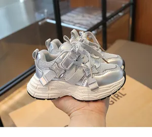 Macro detail of silver breathable chunky sneakers for girls with glitter butterfly bow