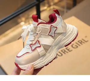 Close-up of girl's breathable cream and red chunky sneaker with glitter details