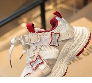 Detail view of girls' breathable sneakers featuring glitter bone patches and mesh panels.