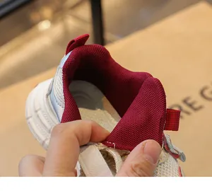 Close-up of the breathable mesh lining and padded collar of girls' chunky sneakers