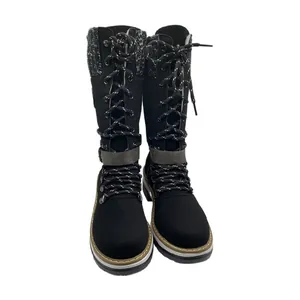 Detailed front view of black mid-calf lace-up boots with buckle strap and knit collar
