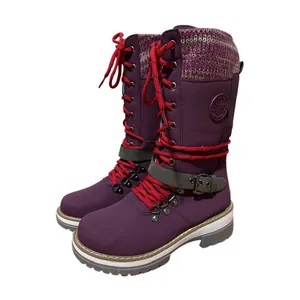 Purple mid-calf boots featuring red laces and a grey buckle strap on thick white soles.