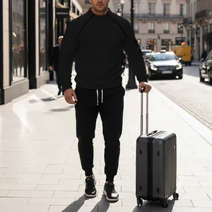 Men's black tracksuit set with stand collar sweatshirt and jogger pants for travel.