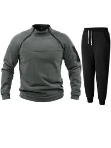 Detail view of men's fleece tracksuit with unique chest zippers and black joggers.