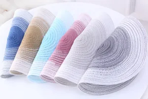 Detailed view of colorful gradient woven placemats in a modern Nordic style set.