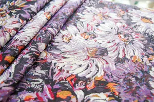 Close-up of high-density yarn-dyed tablecloth with purple floral jacquard weave.