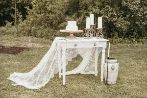 French style white lace table runner draped on a vintage outdoor wedding table setting