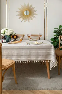 Detailed view of boho cotton linen tablecloth with tassel fringe and embroidery