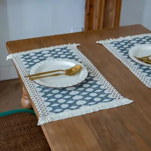 Detail view of farmhouse woven cotton linen placemat with blue geometric pattern and fringe