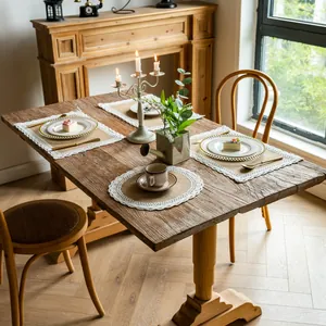 Rustic braided cotton linen placemats with lace borders on a vintage wooden dining table