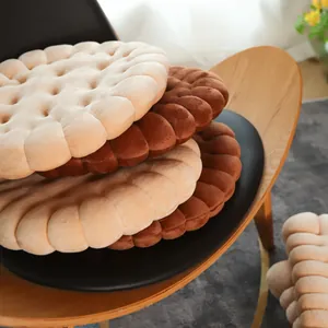 Close-up of decorative stacked round biscuit cushions in beige and brown soft plush fabric