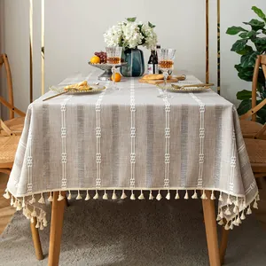 Beige cotton linen tablecloth with floral embroidery and tassel fringe details