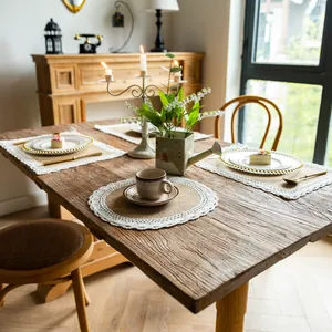 Rustic jute placemats with delicate lace trim displayed on a vintage wooden dining table