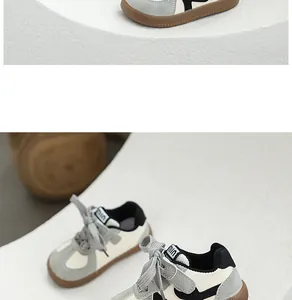 Close-up of children's grey and cream German trainer shoes with brown gum soles