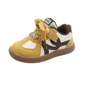 Detail of children's German trainer style sneakers in yellow leather with soft gum sole