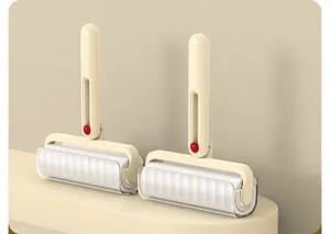 Set of two creamy beige foldable lint rollers for efficient pet hair and dust removal.