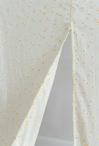 Close-up of white fabric door curtain with delicate daisy pattern and stripe texture finish