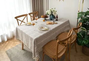 Vintage cotton linen tablecloth with white embroidered stripes and tassel fringe details.
