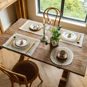 Rustic burlap placemats with white lace trim set on a vintage wooden dining table scene