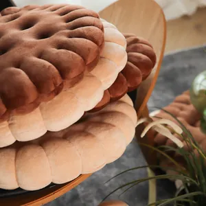 Soft stacked biscuit shaped plush floor cushions in chocolate and tan biscuit colors.