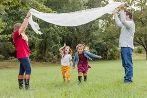 French white lace tablecloth shown in a family outdoor scene as a versatile decorative cover.