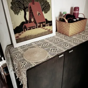 Detailed view of a vintage crochet lace table runner with elegant hollow-out patterns