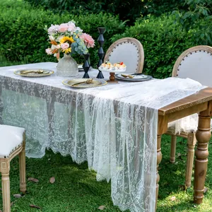 Detailed view of white lace table runner elegantly styled on a wooden dining table