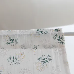 Close-up macro view of delicate floral pattern on white cotton short curtain fabric.