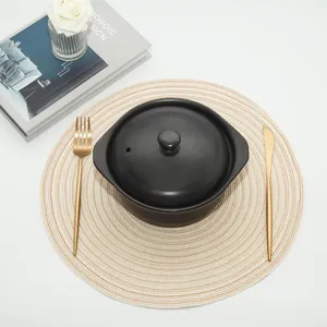 Detailed top view of a circular woven placemat with elegant spiral heat resistant texture