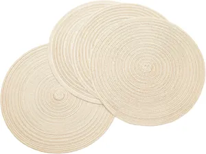 Close-up detail of beige round woven placemats showing the intricate heat-resistant texture