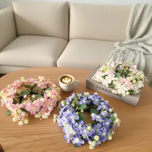 Artificial wild flower candle wreaths in pink and purple for home tabletop decor