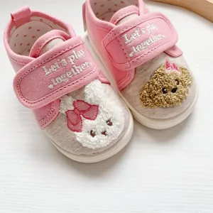 Close-up of pink baby walking shoes with cartoon rabbit towel embroidery and soft soles