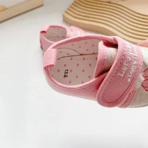 Detailed view of pink baby walking shoe with towel embroidery and soft polka dot lining