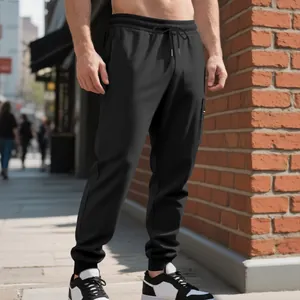 Detail view of men's heavy knit black joggers with functional side cargo pocket outdoors