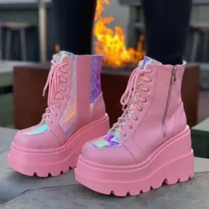 Detailed view of pink high-top platform boots featuring holographic iridescent panels