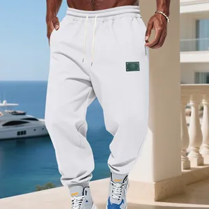 Detail of men's white fleece-lined joggers with a drawstring waist and elastic cuffs.