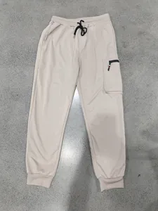 Heavy-duty men's beige cargo joggers featuring drawstring waist and zipped side pocket.