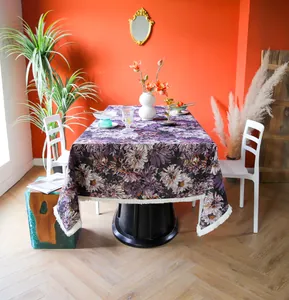 Detailed view of purple floral jacquard tablecloth in a modern dining room setting