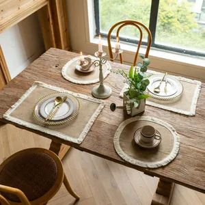 Rustic burlap placemats with fringe in rectangular and round shapes on wooden table