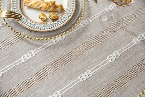 Close-up of retro country cotton linen tablecloth with white hollow embroidery detail.
