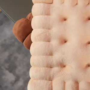 Macro view of soft plush biscuit-shaped cushion with detailed texture and beige color