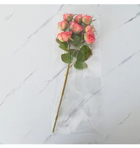Detailed view of 8-head artificial roses bouquet in a clear protective plastic sleeve